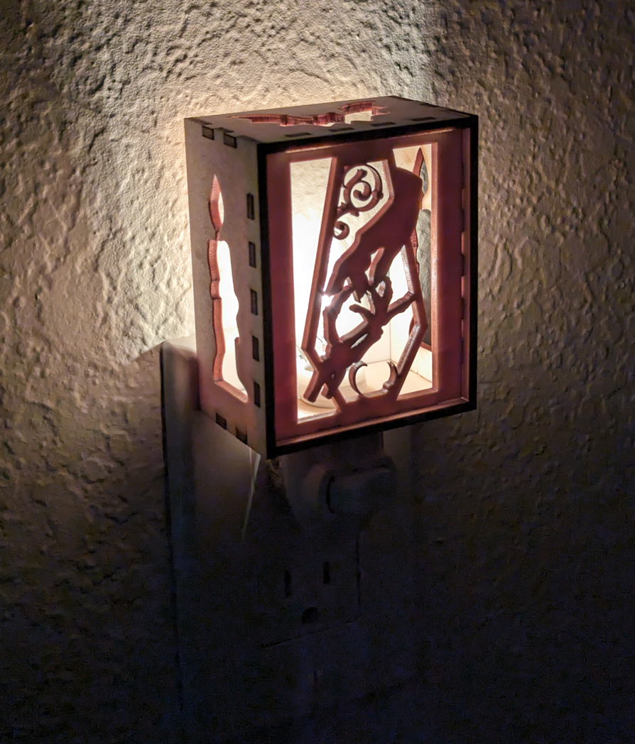 Halloween themed nightlight, skeletal hand meeting human hand over a coffin shaped cutout