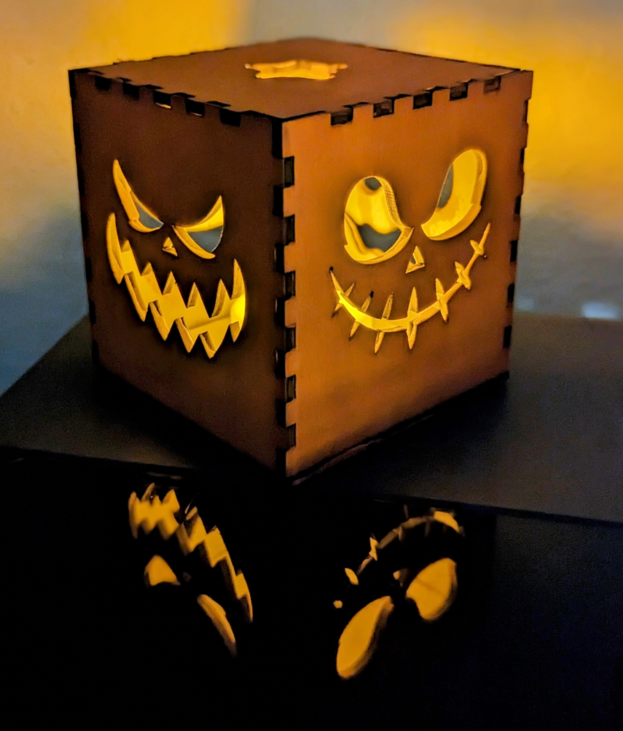 Halloween pumpkin box cover for LED tealights, jack-o-lantern face cutouts